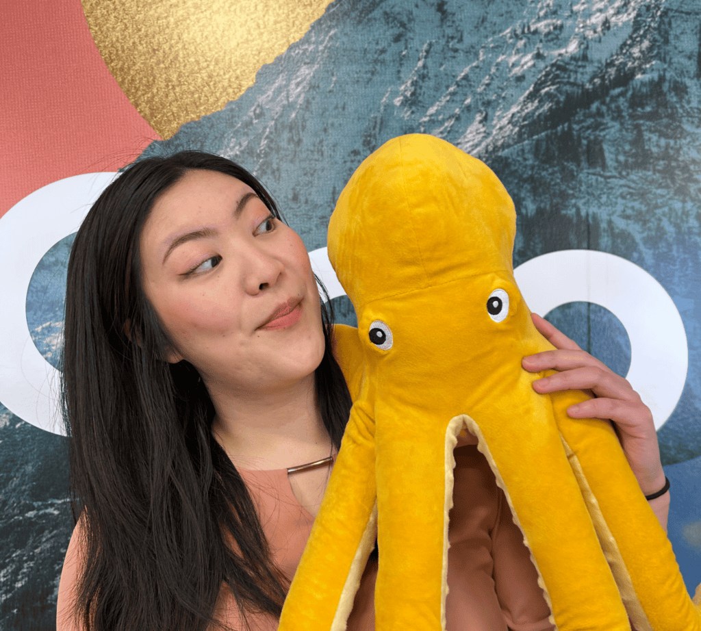 Mental Health Month 2025 1 Kickstand Youth Action Council Member at Kickstand Edmonton Launch event posing with an Octopus Plushie