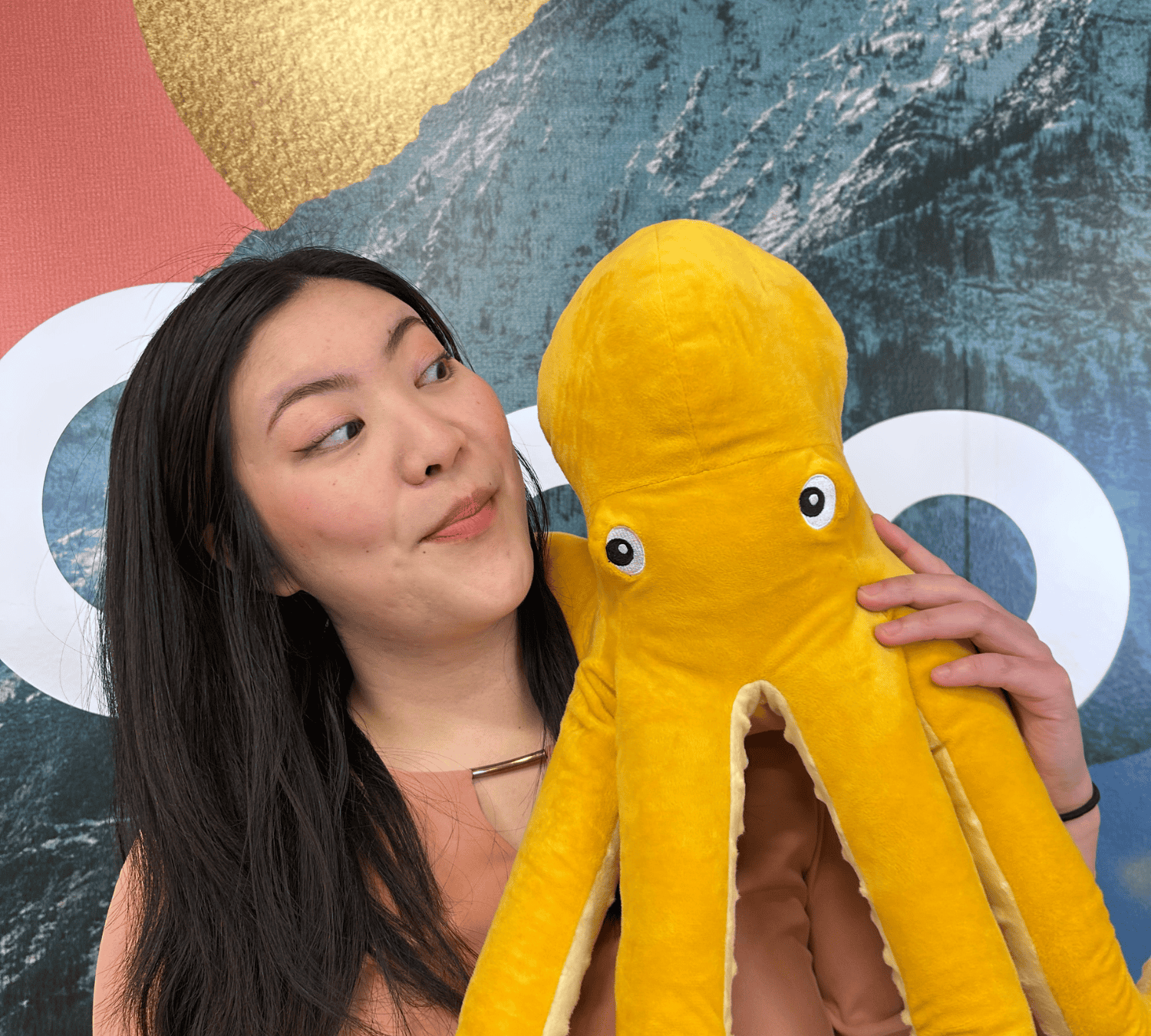 Kickstand Youth Action Council Member at Kickstand Edmonton Launch event posing with an Octopus Plushie